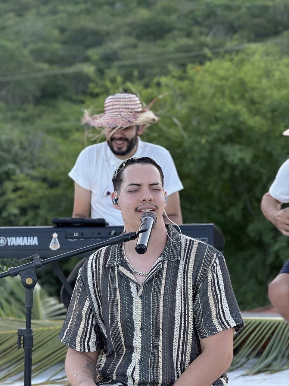 Felipe Stan se apresentando ao ar livre com a banda